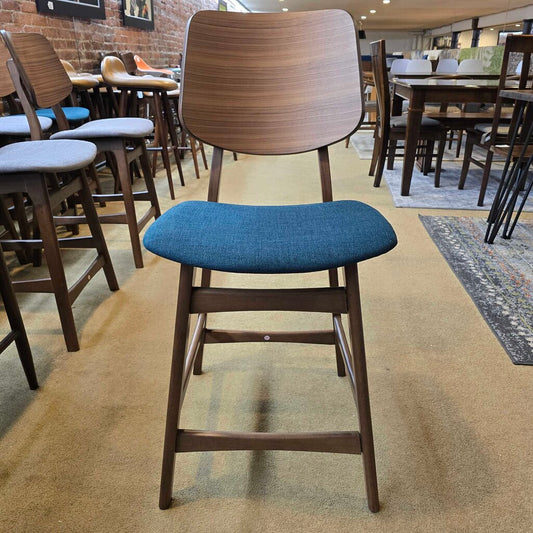 Chair with wooden frame and blue cushion in a restaurant setting