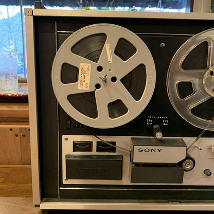 Vintage Sony reel-to-reel tape recorder with reels and control panel.