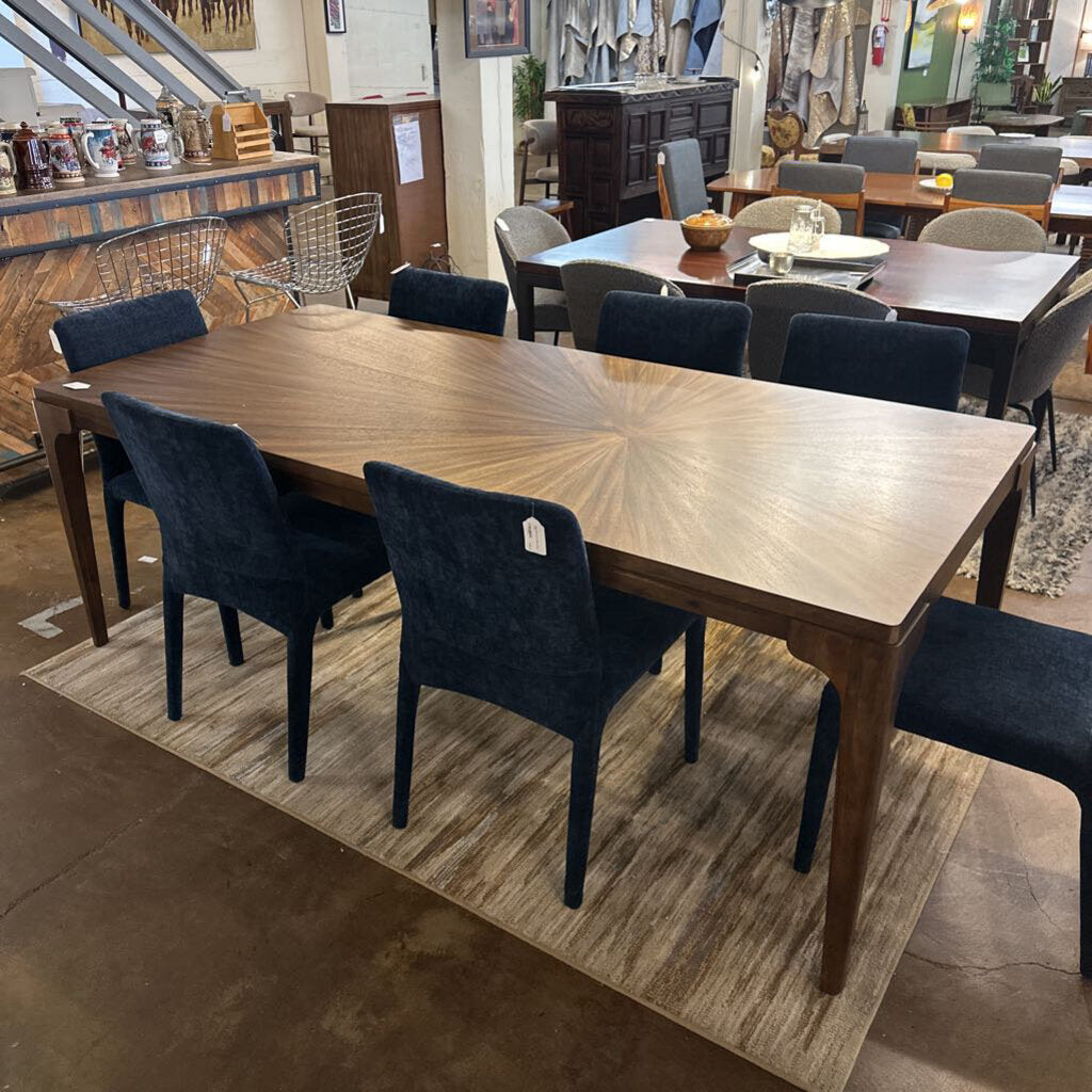 Dining table with chairs in a showroom setting