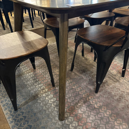 Wooden table and chairs on a patterned rug