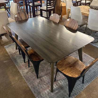 Dining table with wooden chairs in a showroom setting