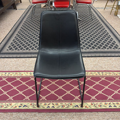 Black chair on a patterned carpet