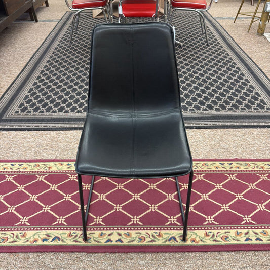 Black chair on a patterned carpet