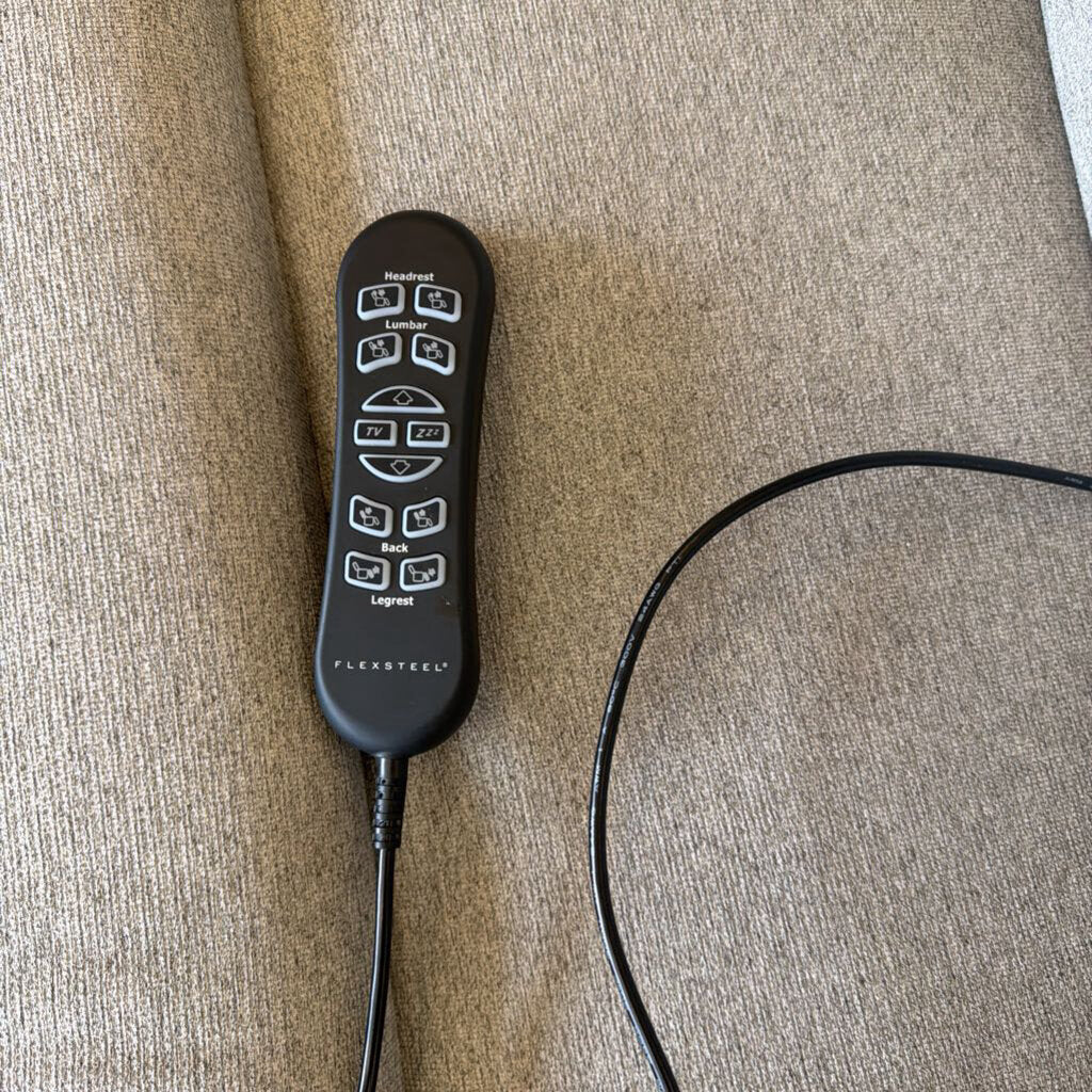 Black electronic device with buttons on a beige surface