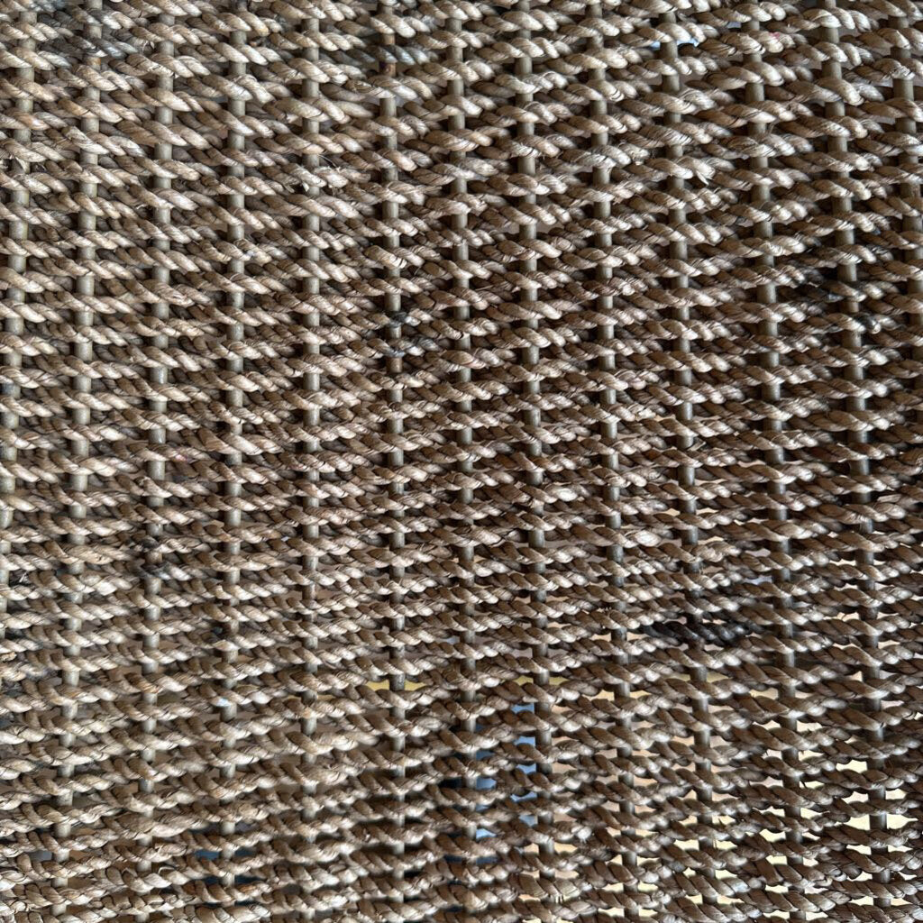 Close-up of a textured brown fabric with a diamond pattern