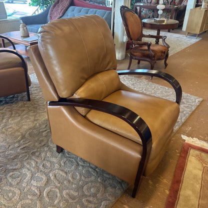 Brown leather armchair in a living room setting with other furniture.