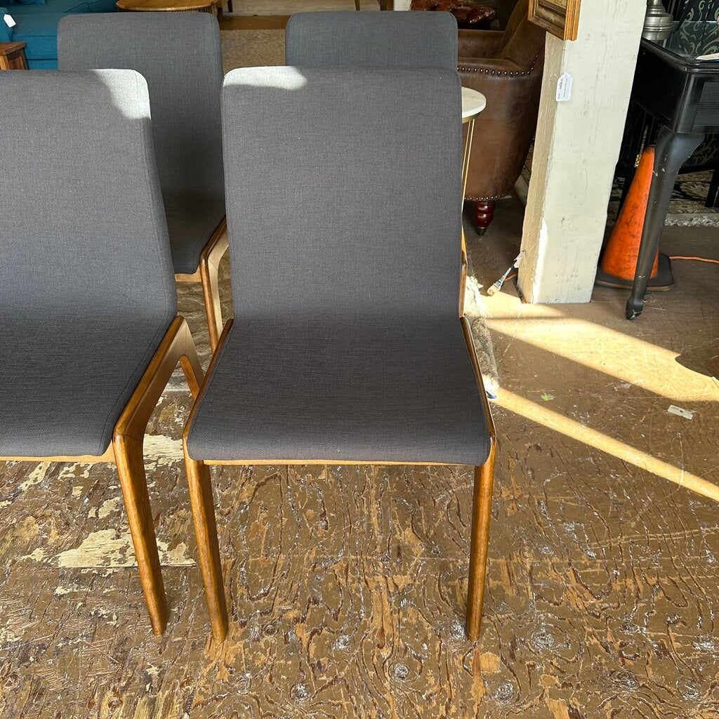 Gray chairs with wooden legs on a worn wooden floor