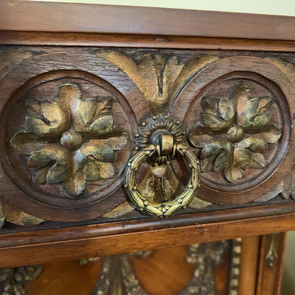 Decorative wooden panel with floral carvings and a metal knocker.