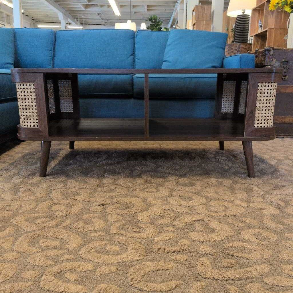 Blue sofa with a wooden coffee table on a patterned carpet
