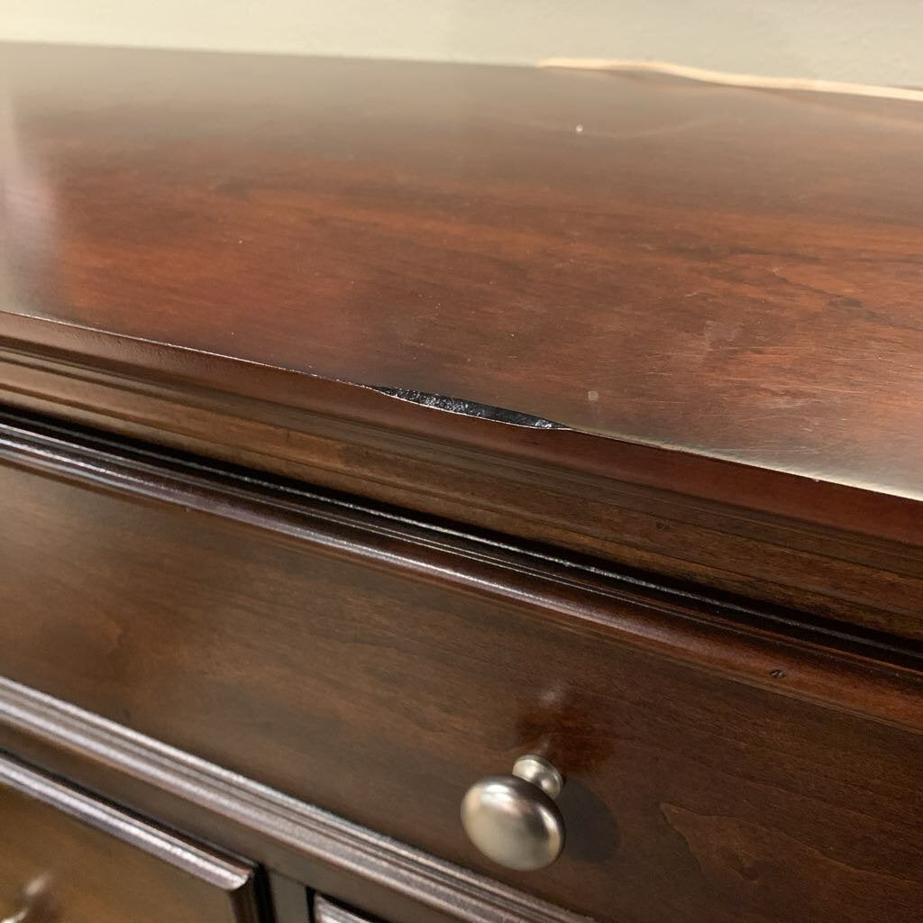 Close-up of a wooden drawer with a metal handle