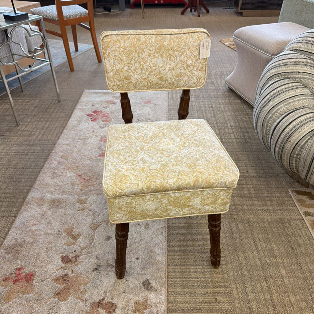 Decorative chair and ottoman set on a patterned rug in a room setting.