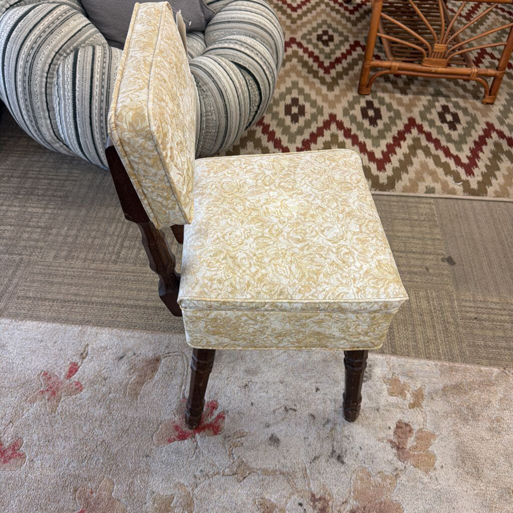 Decorative chair with floral patterned seat in a room with patterned rug and furniture.