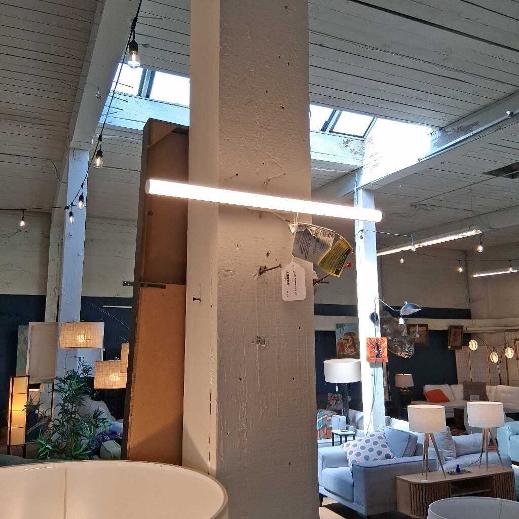 Modern interior design with pendant lights, sofas, and decor elements.