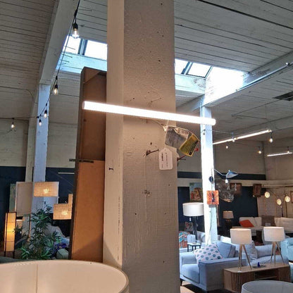 Modern interior design with pendant lights, sofas, and decor elements.