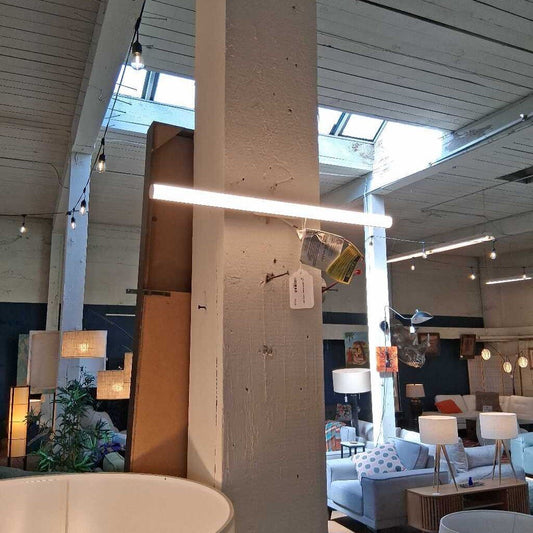 Modern interior design with pendant lights, sofas, and decor elements.