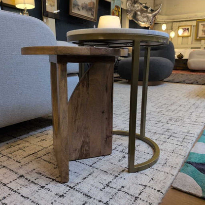 Wooden side table with metal legs in a living room setting