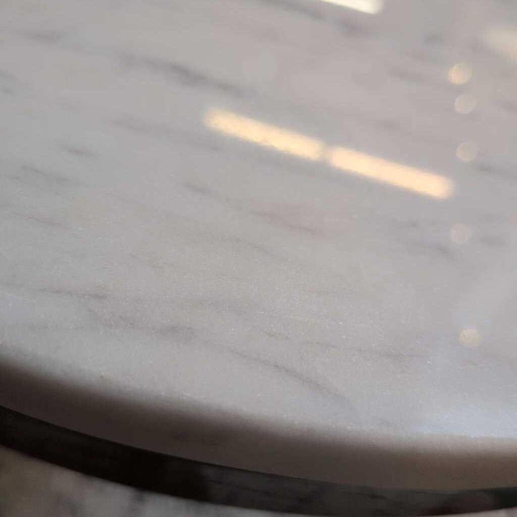 Close-up of a marble-patterned surface with light reflections