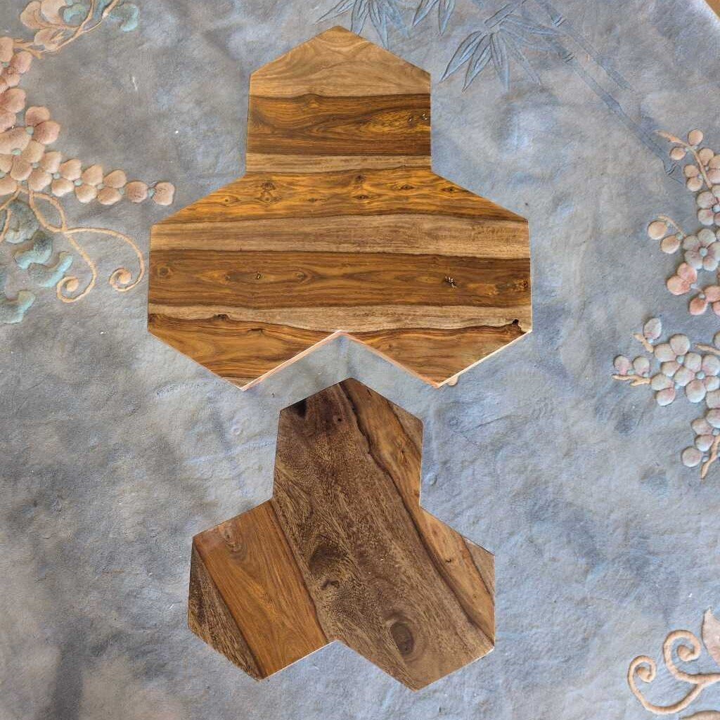 Wooden decorative item on a textured surface with floral elements