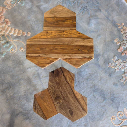 Wooden decorative item on a textured surface with floral elements