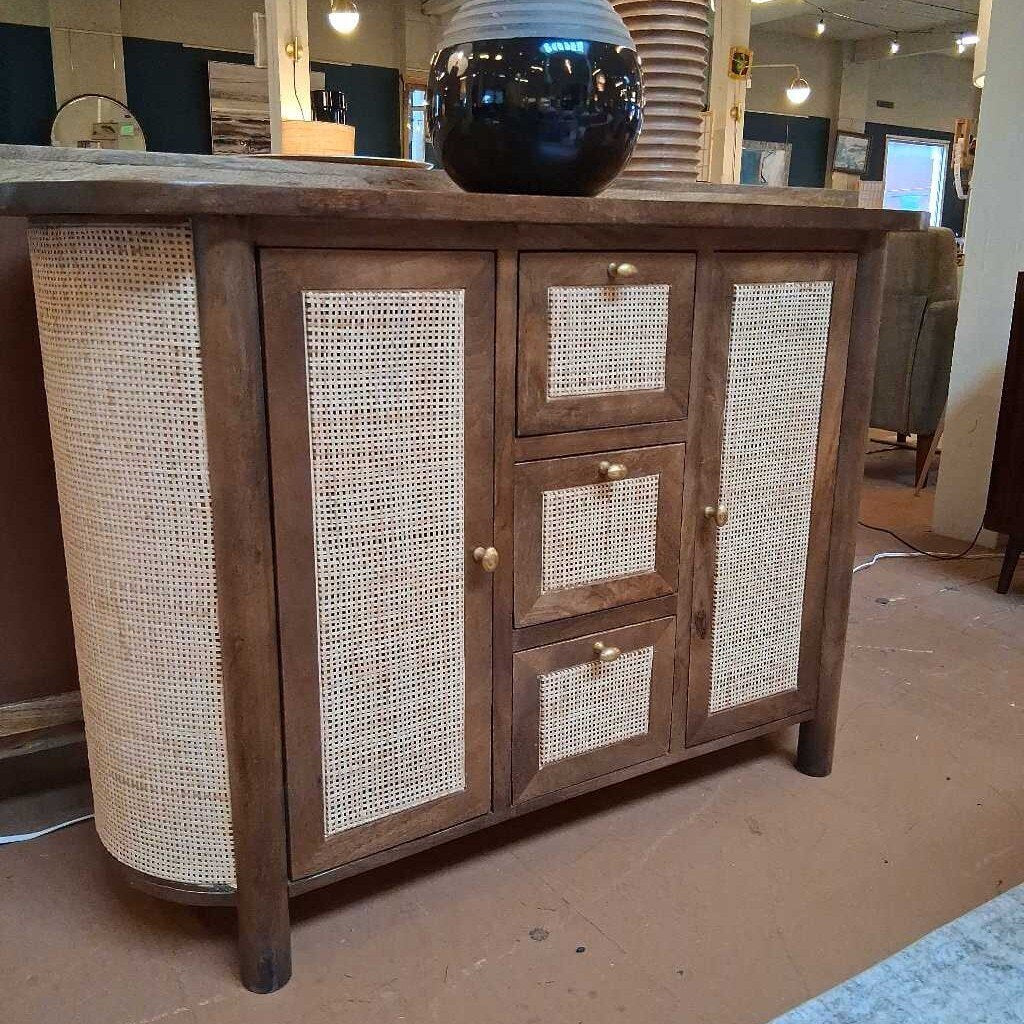 Wooden cabinet with wicker doors in a room setting