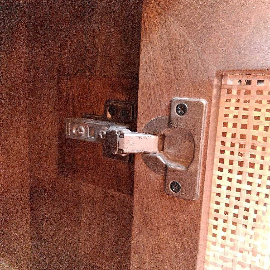 Close-up of a wooden door with a metal hinge