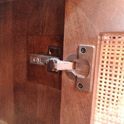 Close-up of a wooden door with a metal hinge