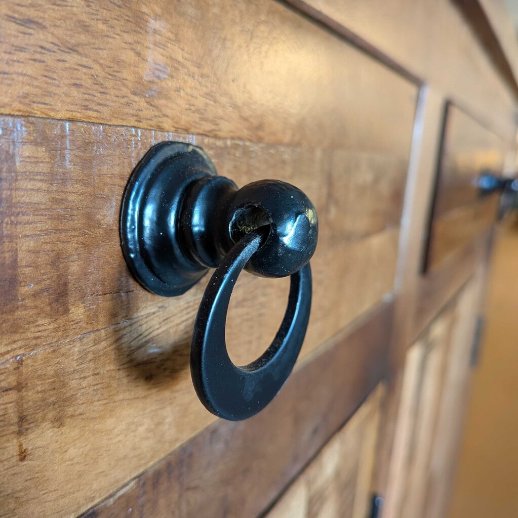 Black door knocker on a wooden door