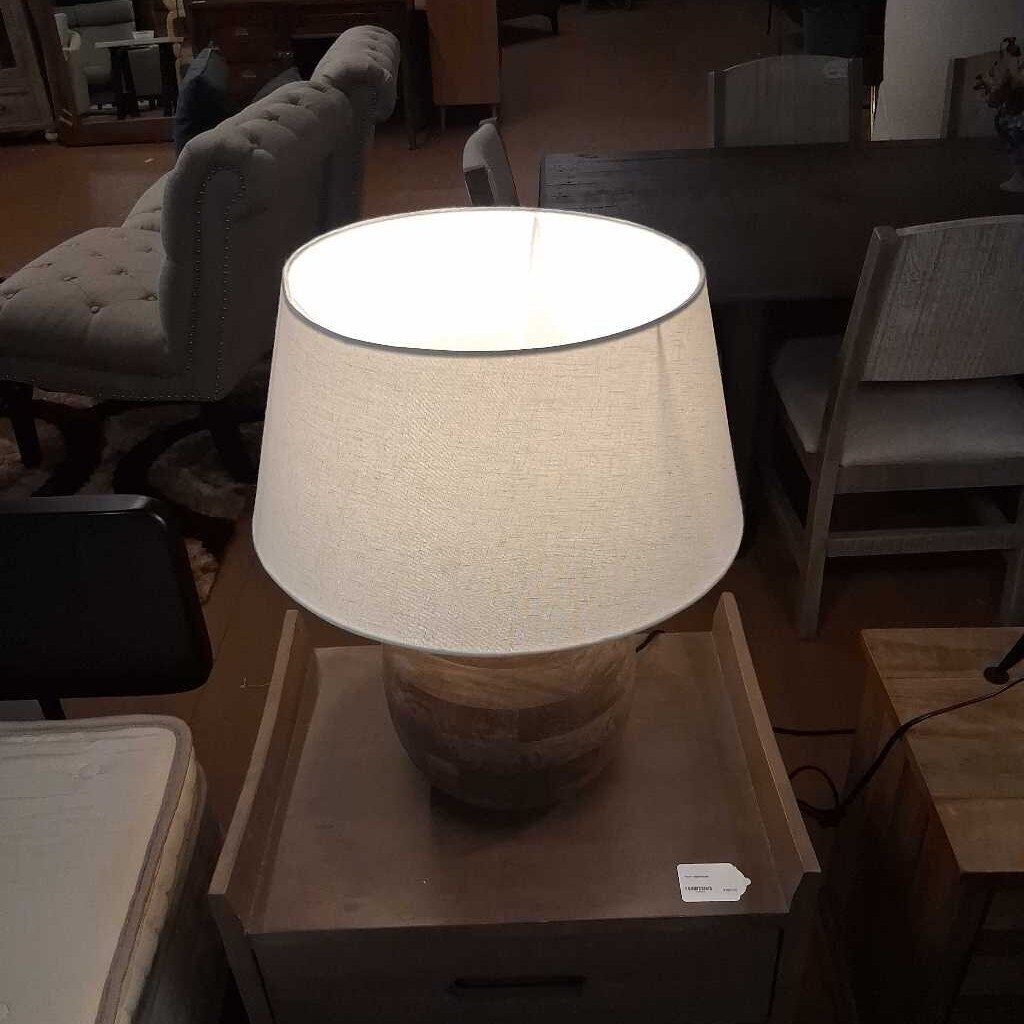Lamp on a wooden table in a room with furniture