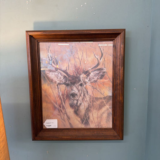 Framed artwork of a deer on a gray wall