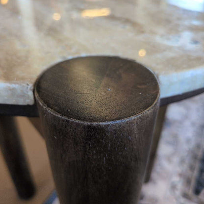 Close-up of a textured cylindrical object on a reflective surface