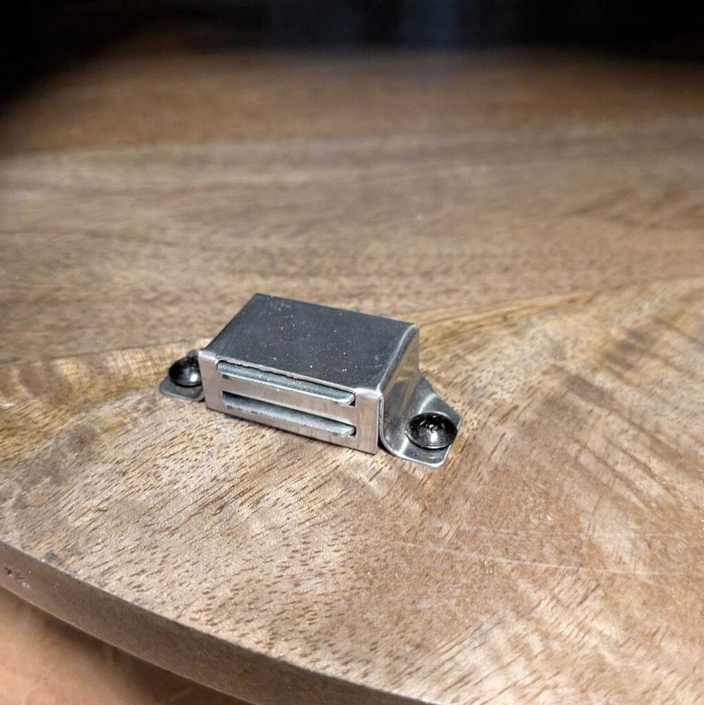 Metallic object on a wooden surface