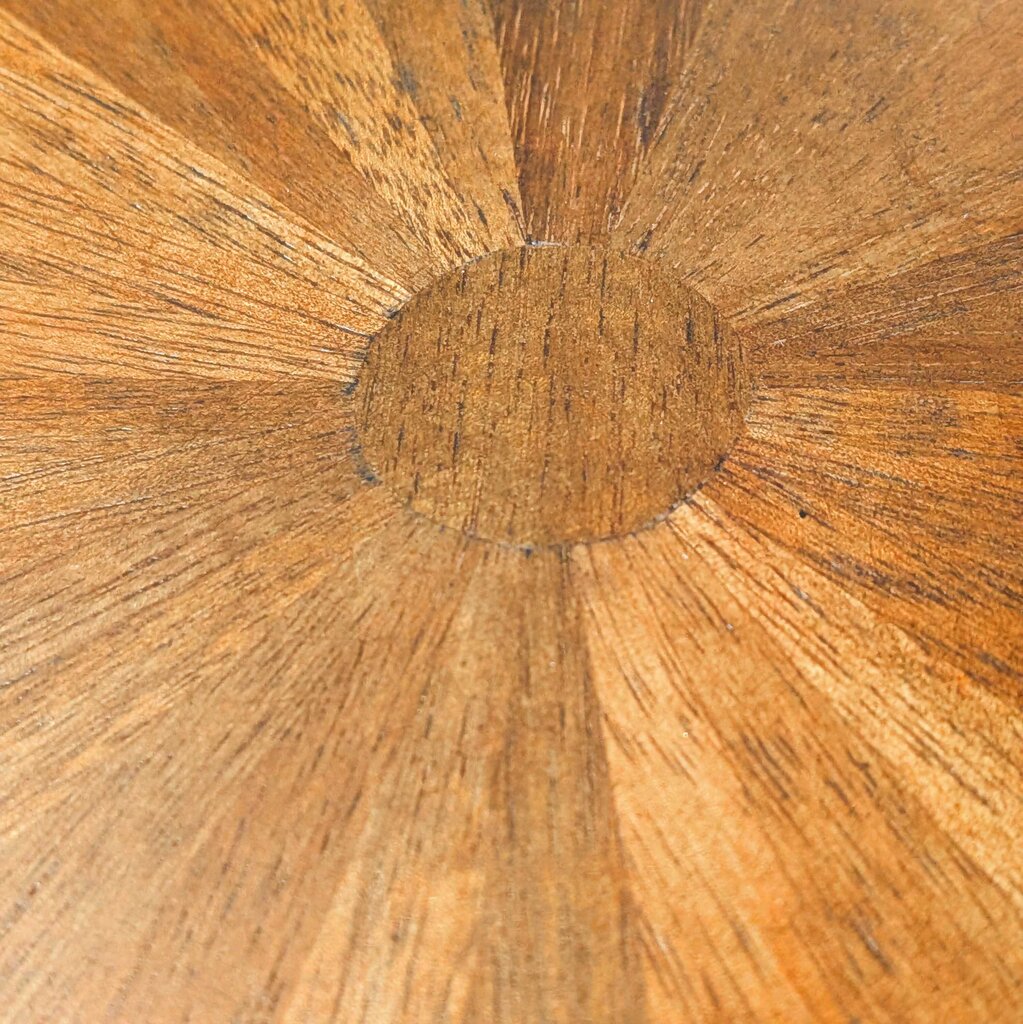 Close-up of a wooden surface with a sunburst pattern
