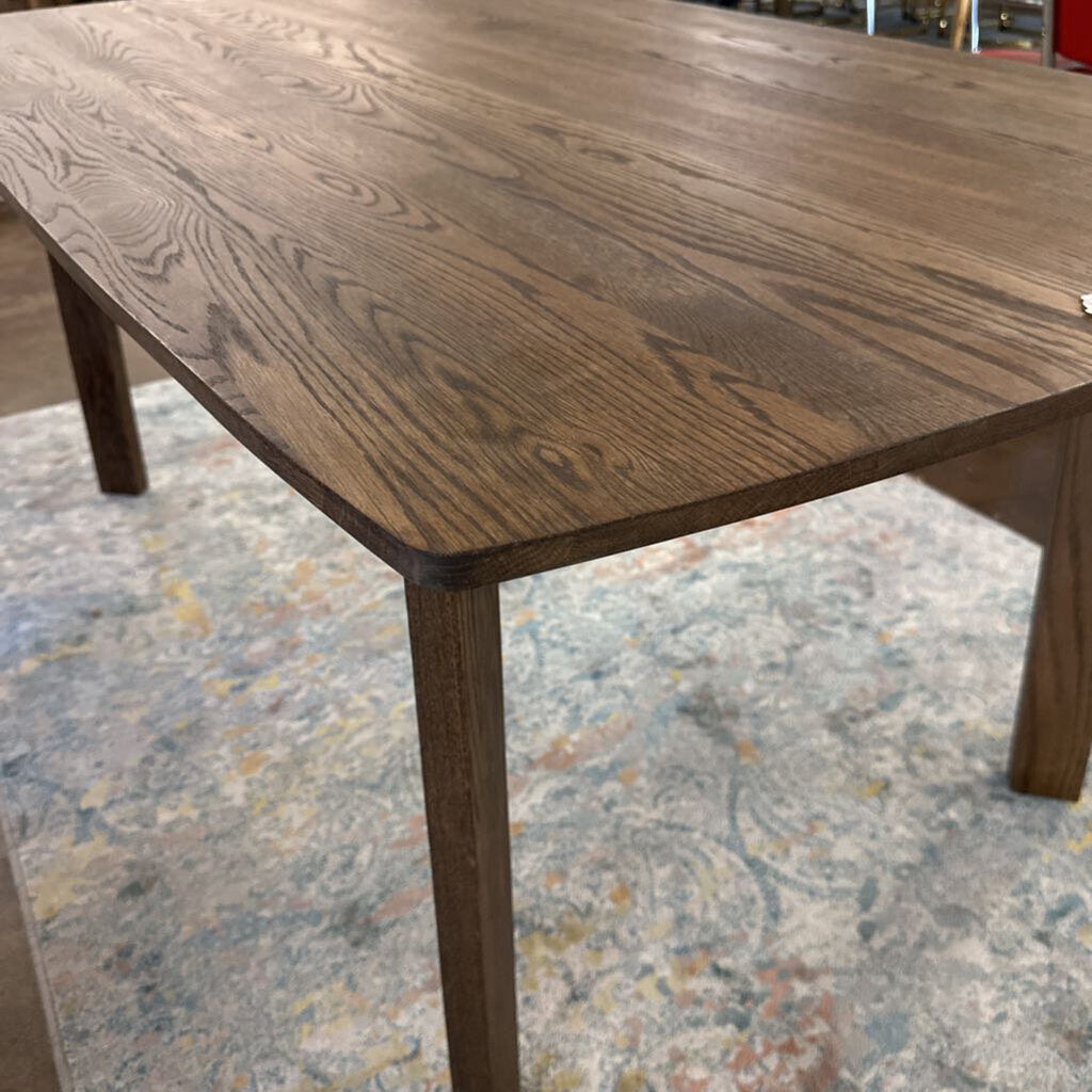 Wooden table with a textured surface on a patterned floor