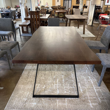 Dining table with metal legs in a showroom setting