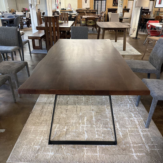 Dining table with metal legs in a showroom setting