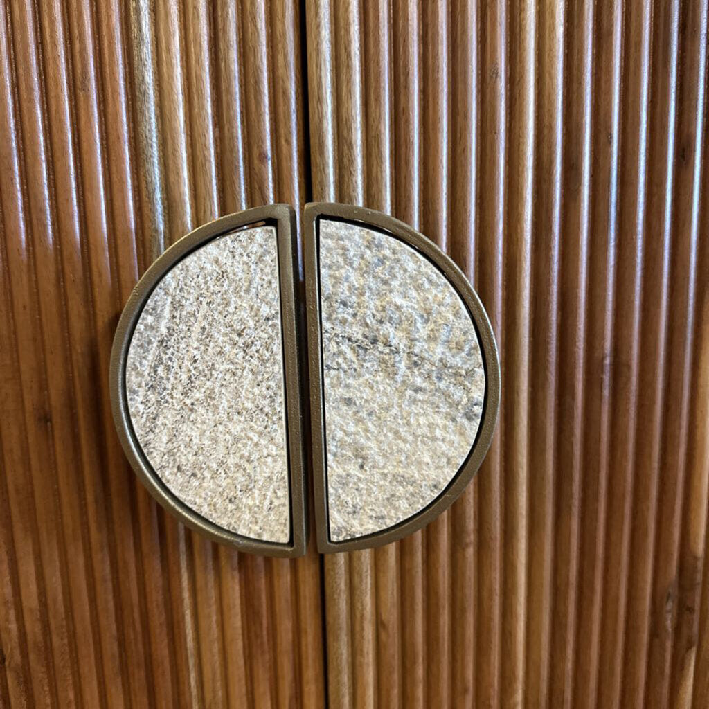 Round metallic door handle on a wooden door