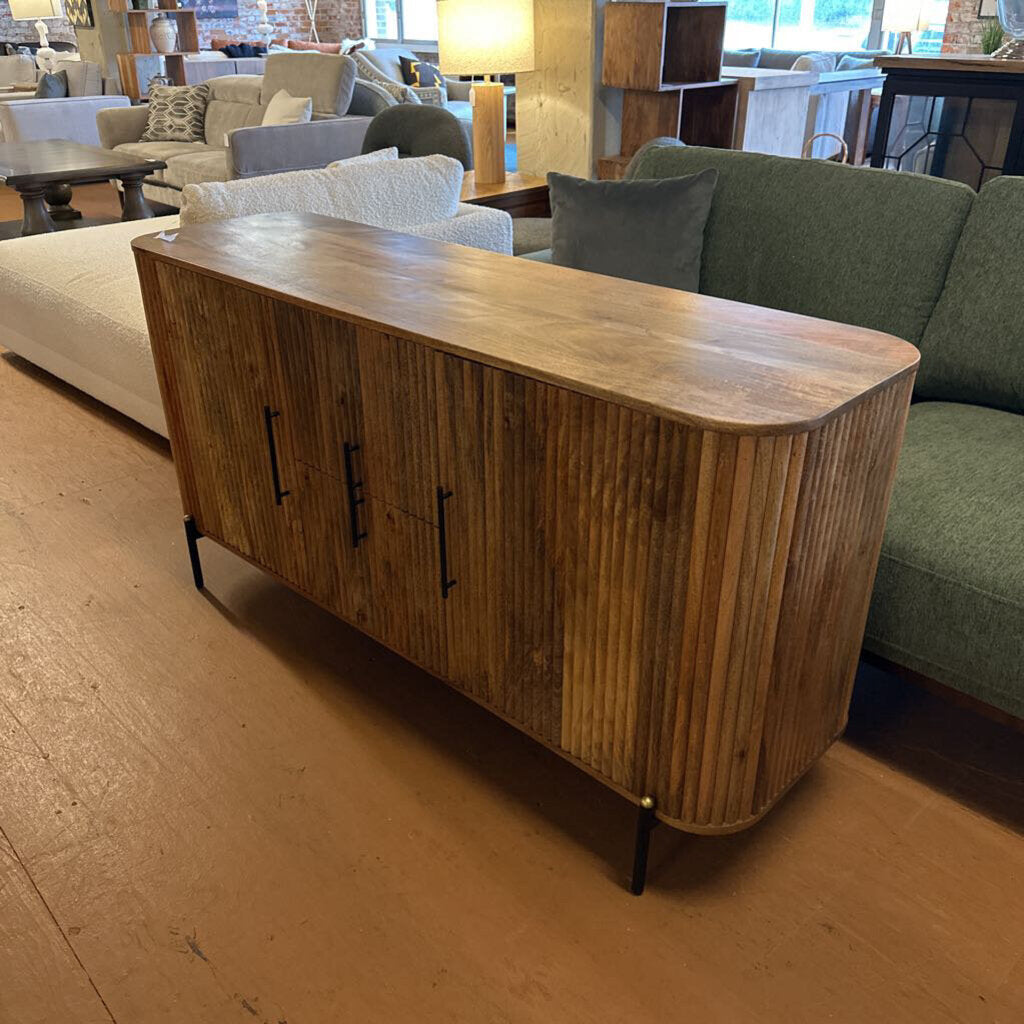 Wooden sideboard in a room with furniture and decor