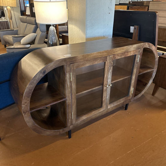 Wooden sideboard with glass doors in a showroom setting