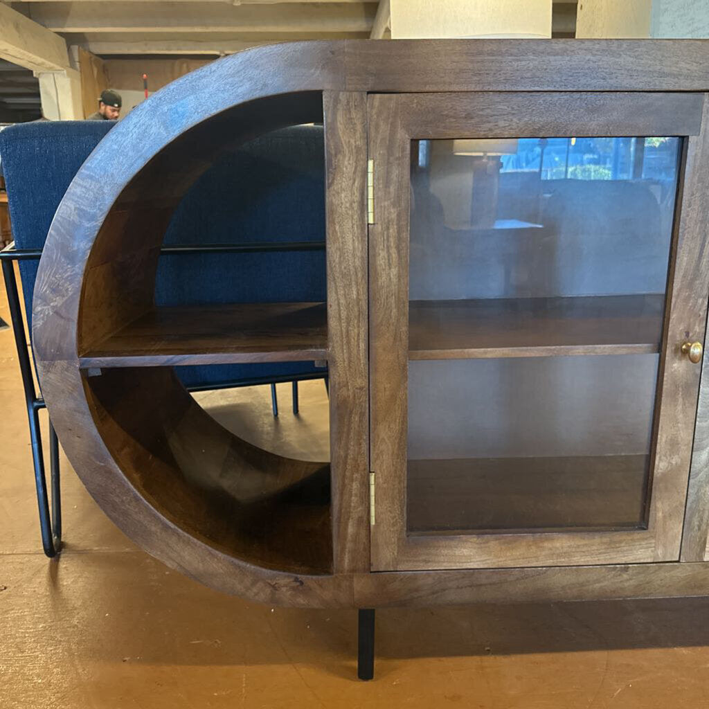 Wooden cabinet with round design on a wooden floor