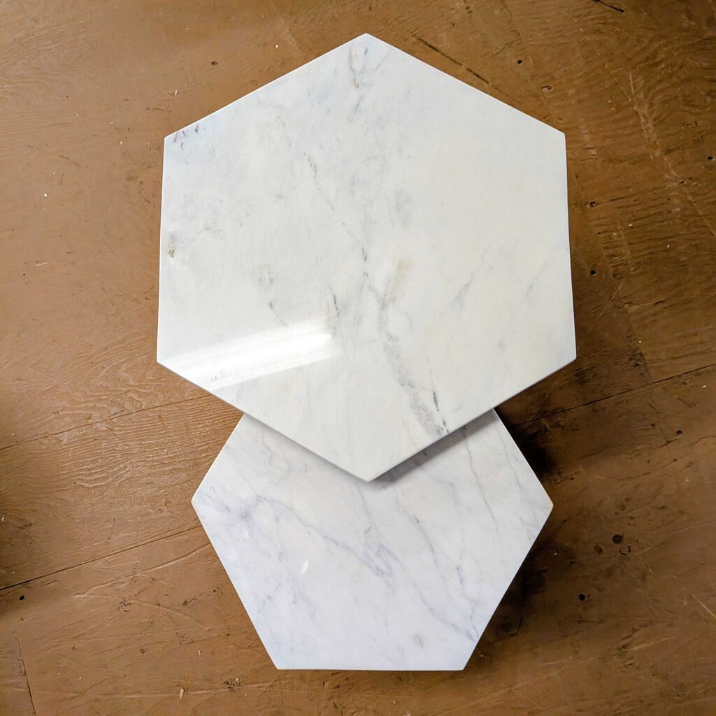 Hexagonal marble coasters on a wooden surface