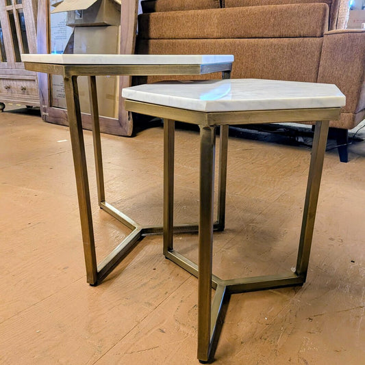 Two marble top side tables with metal legs on a wooden floor.