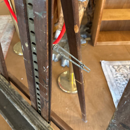 Wooden door with a metal handle and lock mechanism on a wooden floor.
