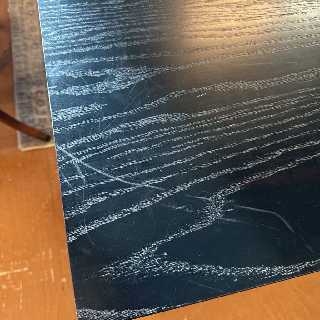 Scratched black surface on a wooden background