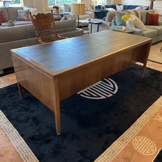 Wooden coffee table in a living room setting with furniture and decor.