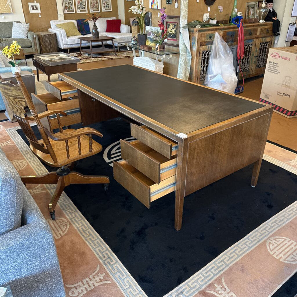 Wooden desk with drawers in a room with furniture and decor