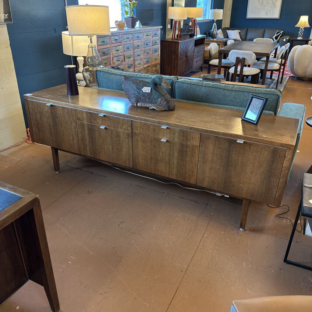 Wooden sideboard in a room with furniture and decor