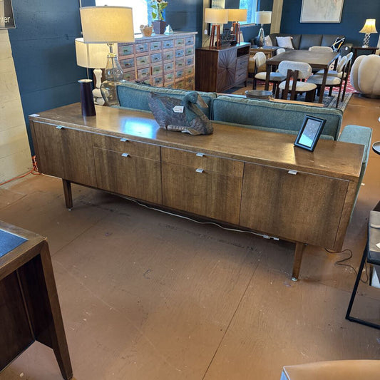 Wooden sideboard in a room with furniture and decor