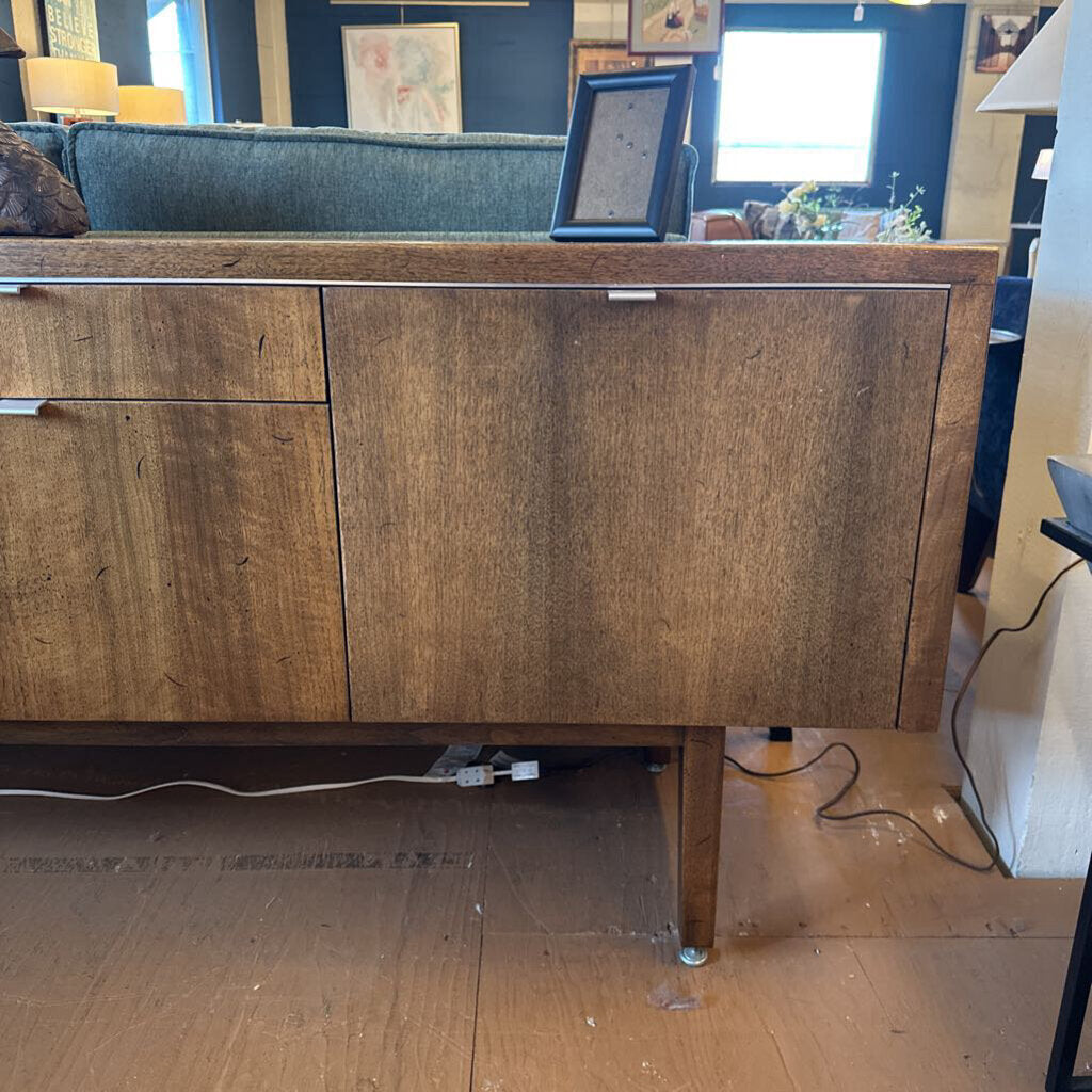 Wooden sideboard in a room with furniture and decor