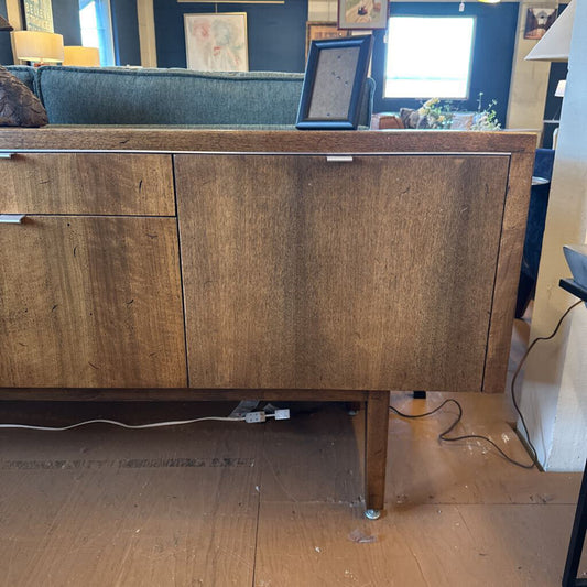 Wooden sideboard in a room with furniture and decor