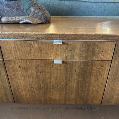 Wooden cabinet with two doors and a decorative item on top